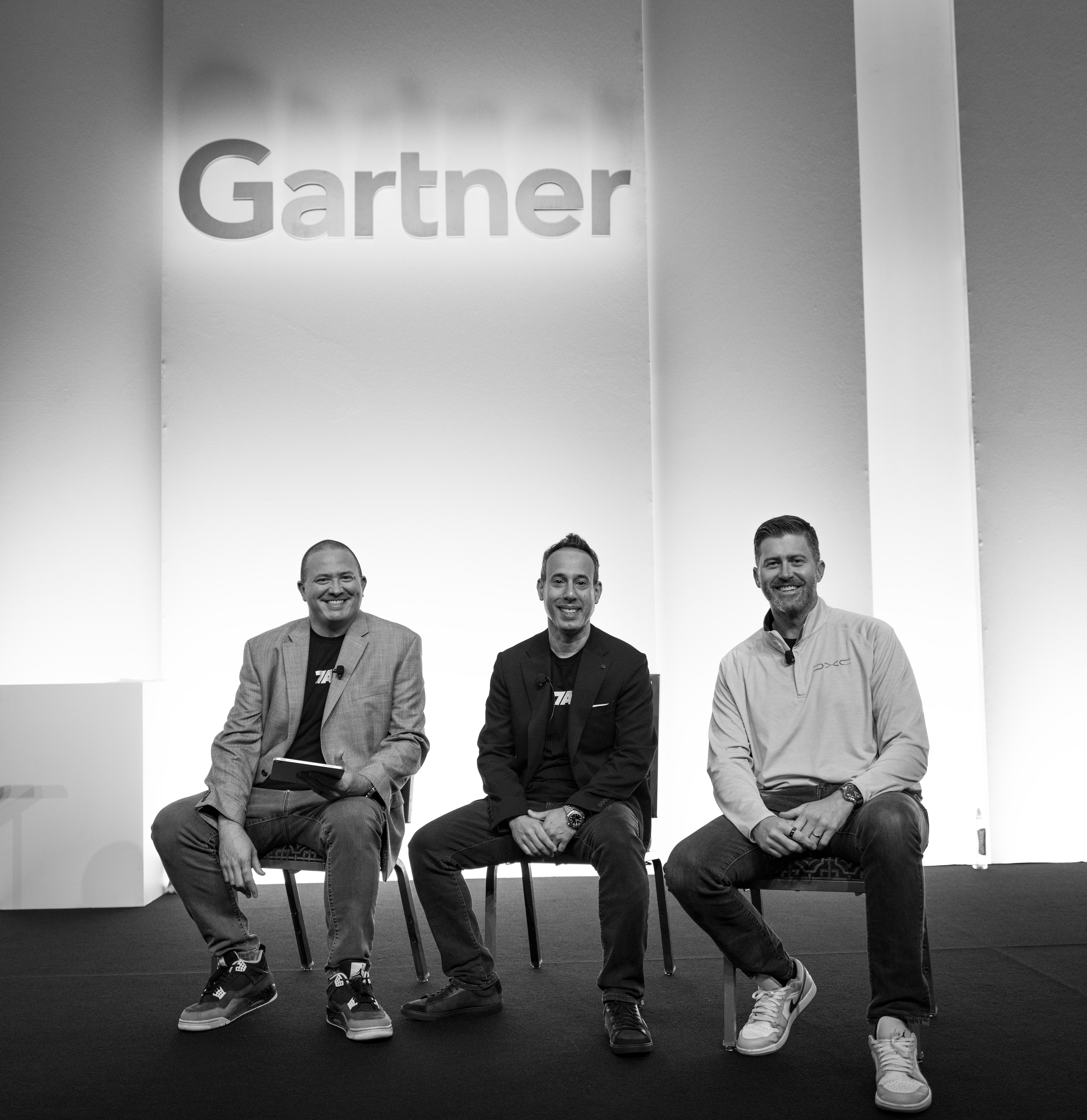 Mike Baker with 7AI's Lior Div and Nate Burke on stage at Gartner